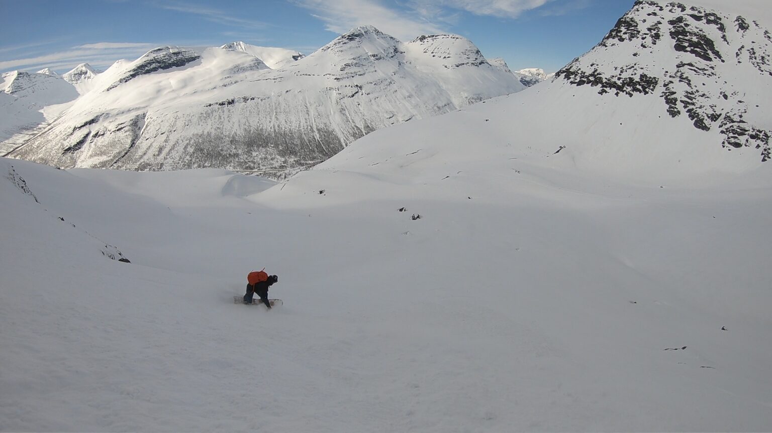 Snowboarding down the open terrain below