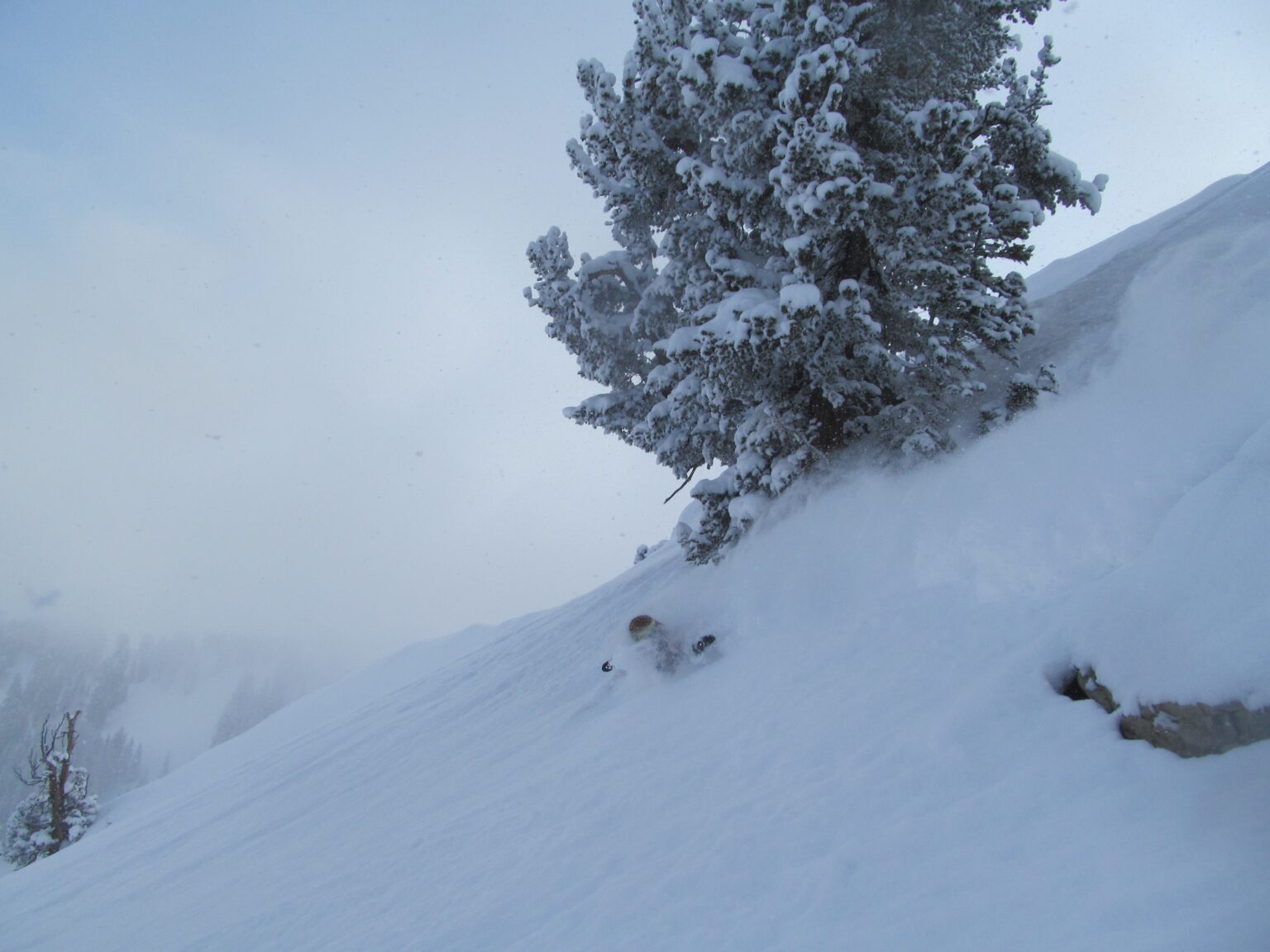 Finding waist deep powder snow while snowboarding the East face of Mount Raymond