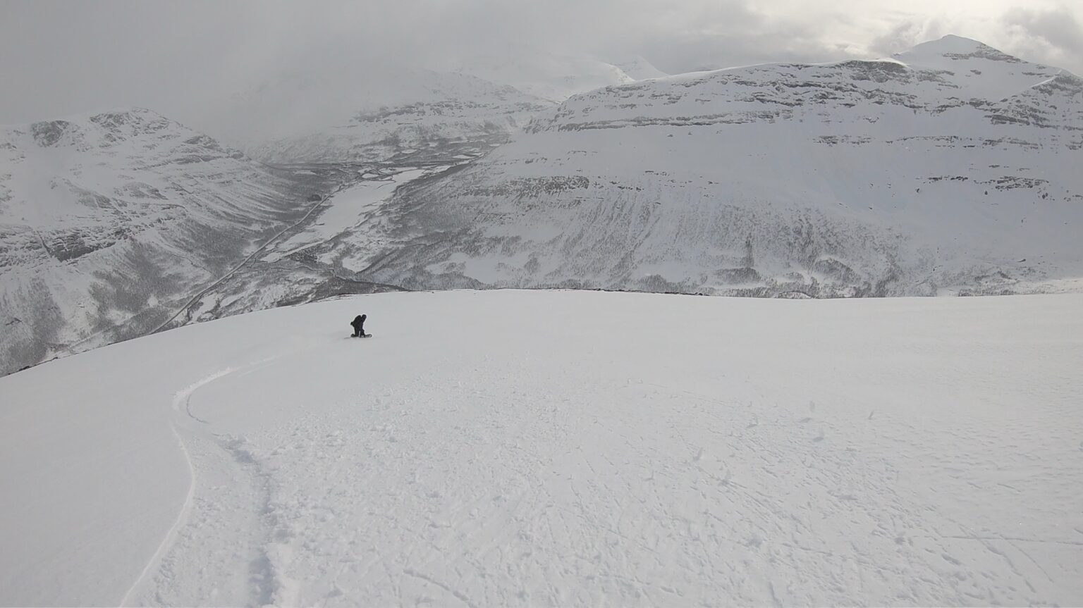 Making our final snowboard turns down