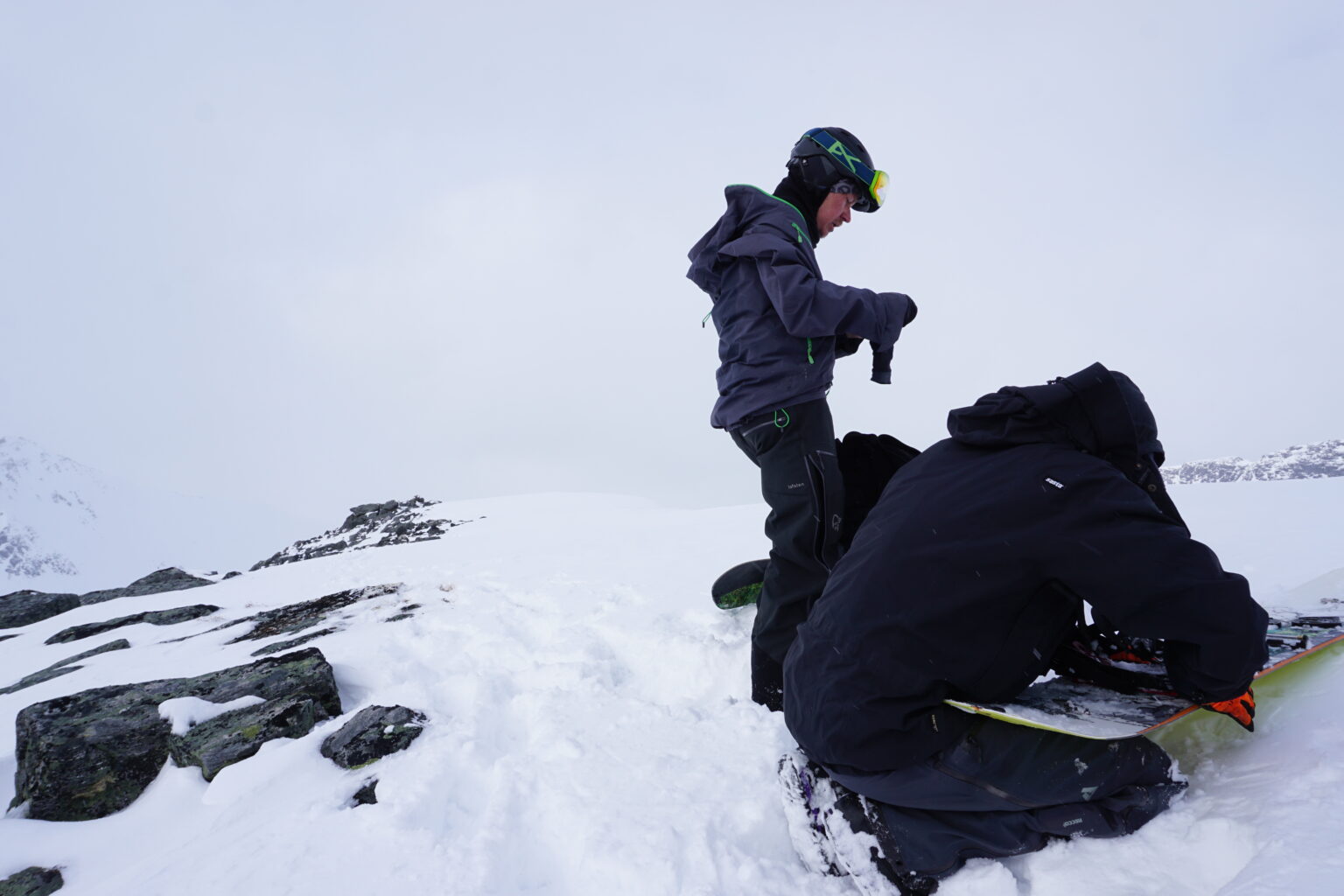 Transitioning to snowboarding on the summit of Kjempetinden while linking up Oksetinden and Kjempetinden