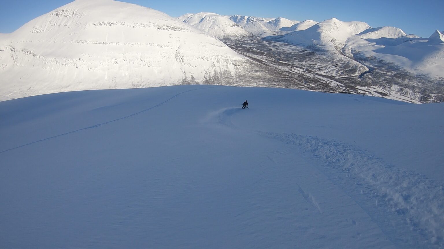 Skiing great powder snow in the Northeast bowl of Sjufjellet