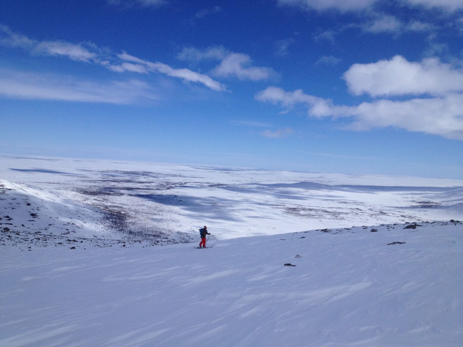 Ski touring up with the flat terrain of Finnish Lapland in the distance