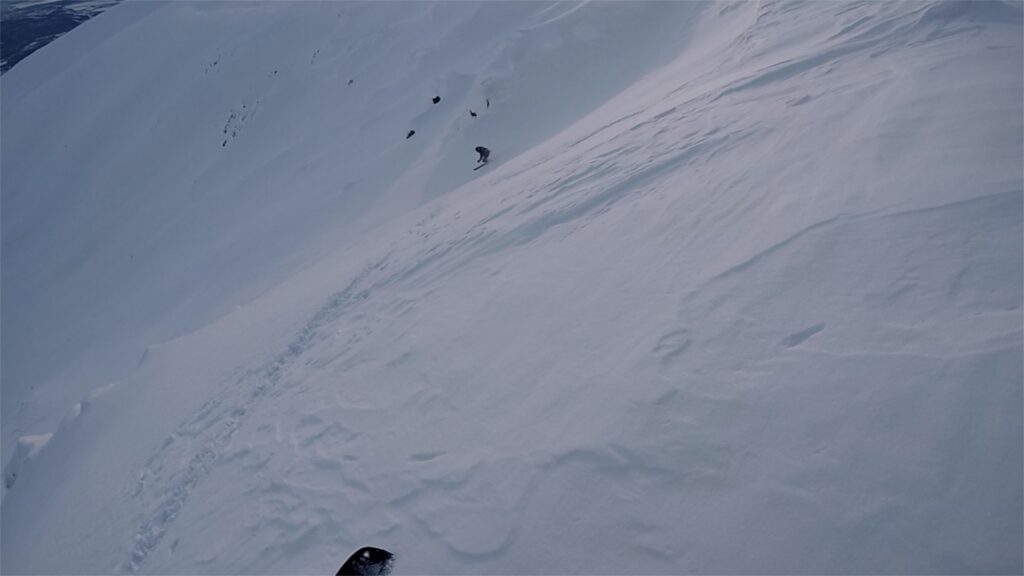 Snowboarding down into an open bowl