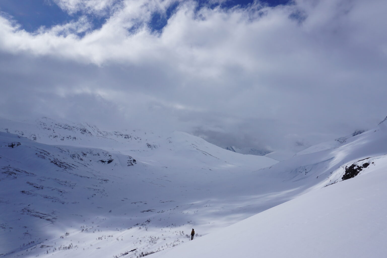 Climbing up a mountain as the clouds grow int he distance