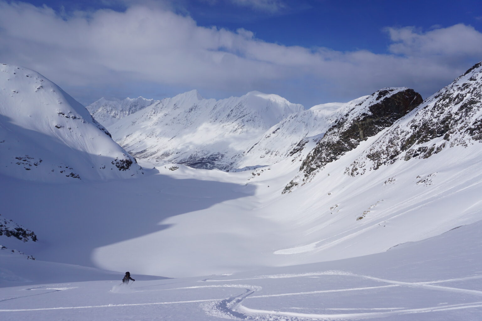 Illka making ski turns down the glacier