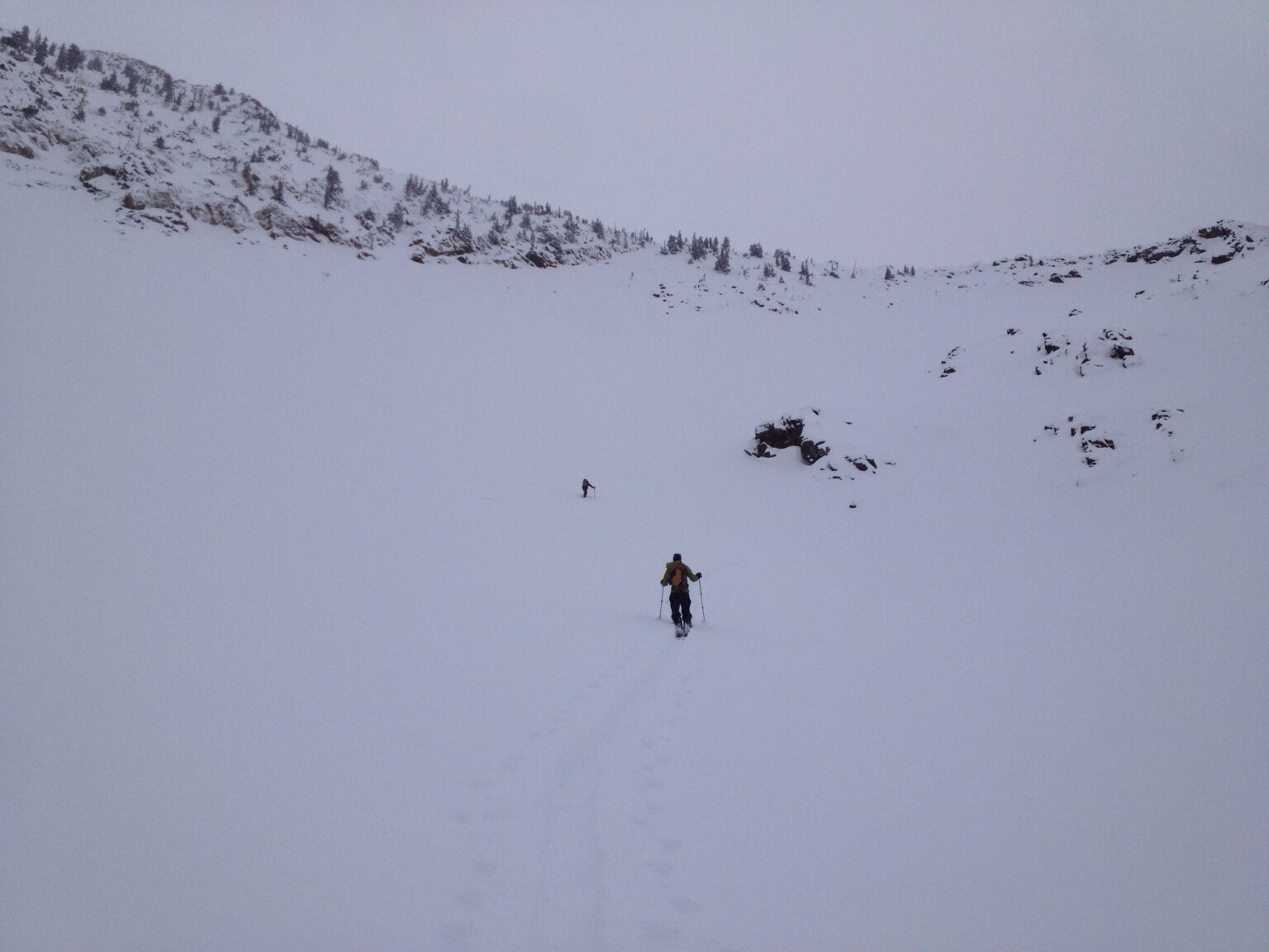 Ski touring up the upper basin in flat light conditions