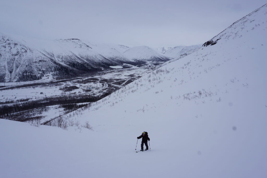 Ski touring up Mount Aikuaivenchorr with the Khibiny Mountains in the distance