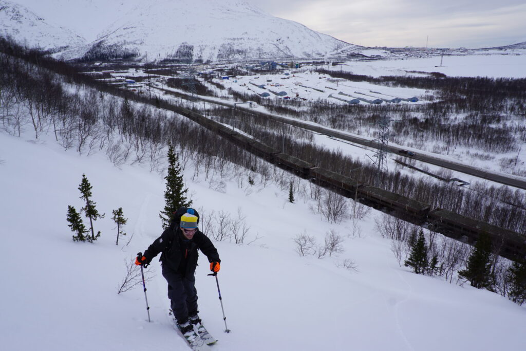 ski touring with a train heading by underneath 